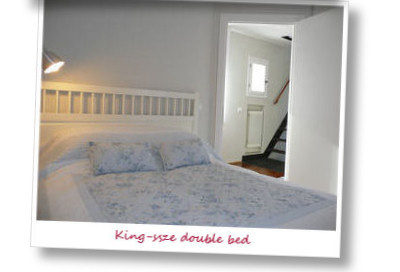 Double bedroom with king-sized bed. Fitted wardrobe